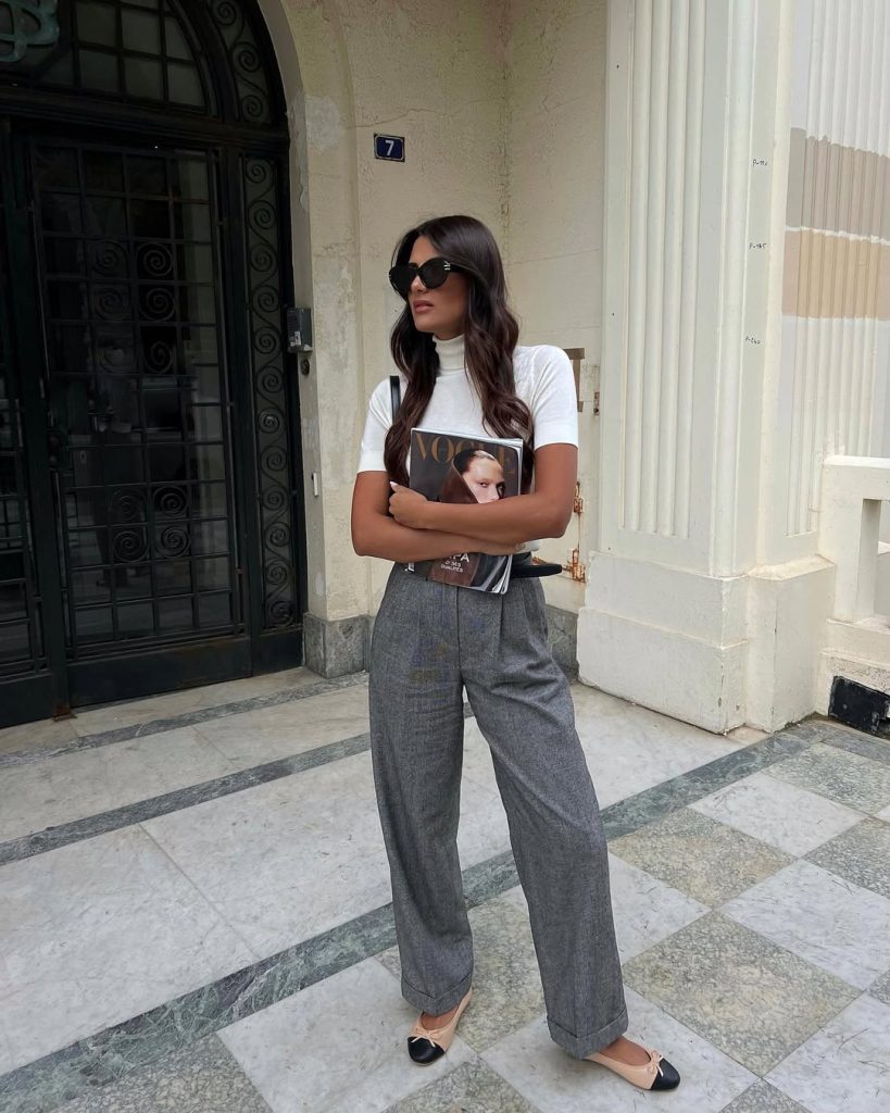 summer work outfit with white short-sleeve mock neck, gray tailored trousers, black-toe ballet flats and statement sunglasses