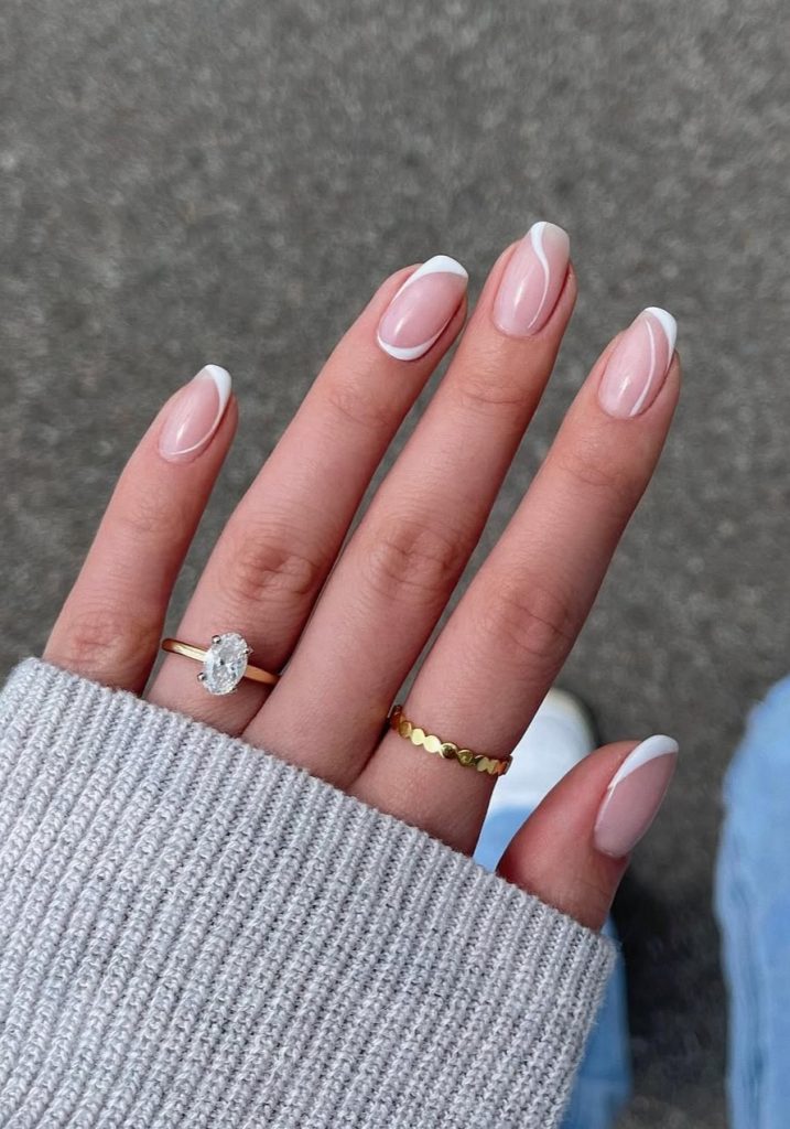 Almond shaped elegant summer nails with pink base and white French tips with thin outlines