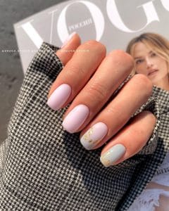 Classy short summer nails with elegant pale pink and sage green polish featuring delicate gold foil accents