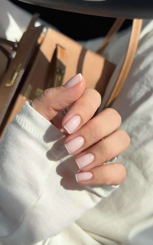 classic old money summer  nails with translucent pink base and ultra-thin white French tips
