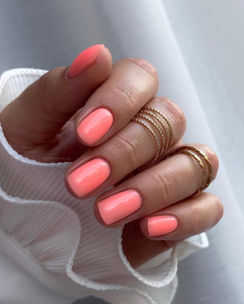 Classy June nails with short square shape featuring bright coral polish
