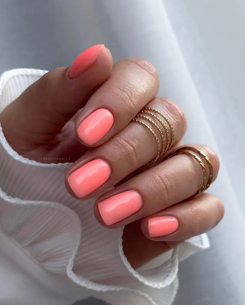Classy June nails with short square shape featuring bright coral polish
