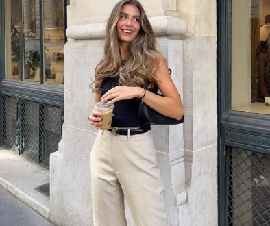Classic summer work outfit with navy fitted tank top, beige wide-leg trousers, black leather belt and minimalist gold jewelry