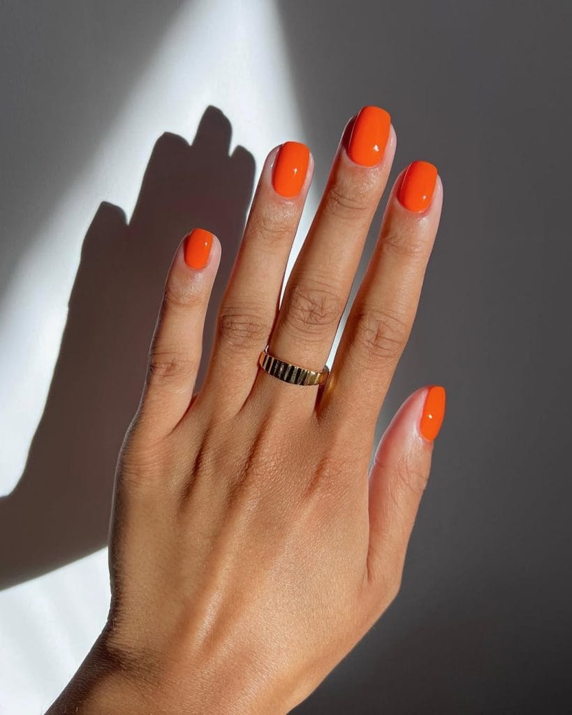 classy short summer nails with bright tangerine orange polish on square shape