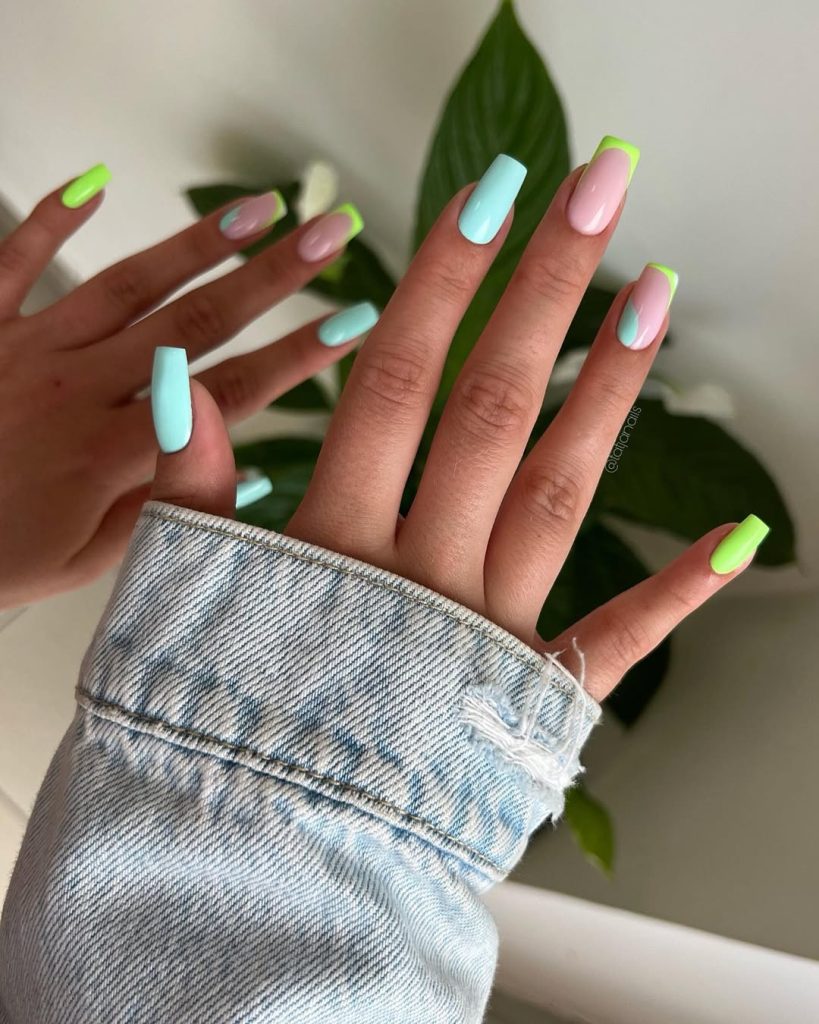 Long square nails in pastel mint, neon lime tips and pink base with abstract designs for tropical summer vibe
