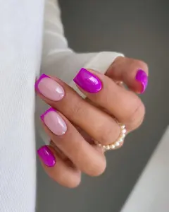 Short nails with alternating neon magenta and milky pink with French tips and pearl accents for feminine summer style