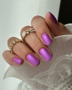 classy short summer nails with vibrant lavender purple polish featuring subtle shimmer finish