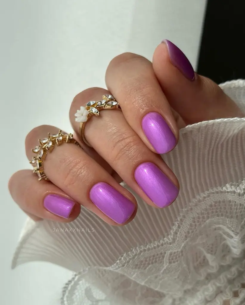 classy short summer nails with vibrant lavender purple polish featuring subtle shimmer finish