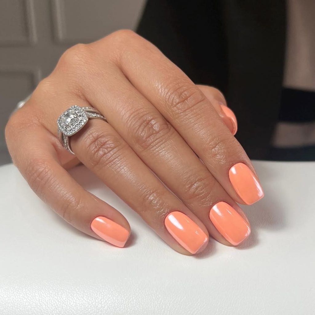 old money short nails with coral orange chrome polish
