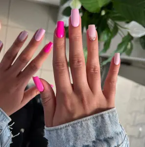 Long square July nails with hot pink to light pink gradient ombre and glitter accent details
