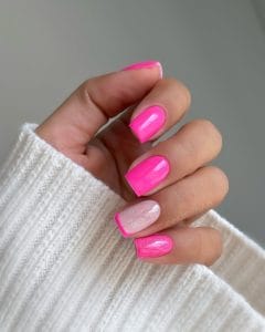 Classy short summer nails with vibrant hot pink polish, transparent glitter accent nail and pink French tips
