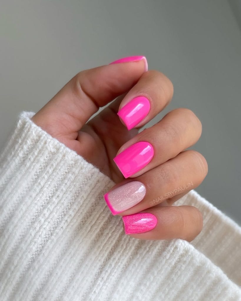 Classy short summer nails with vibrant hot pink polish, transparent glitter accent nail and pink French tips