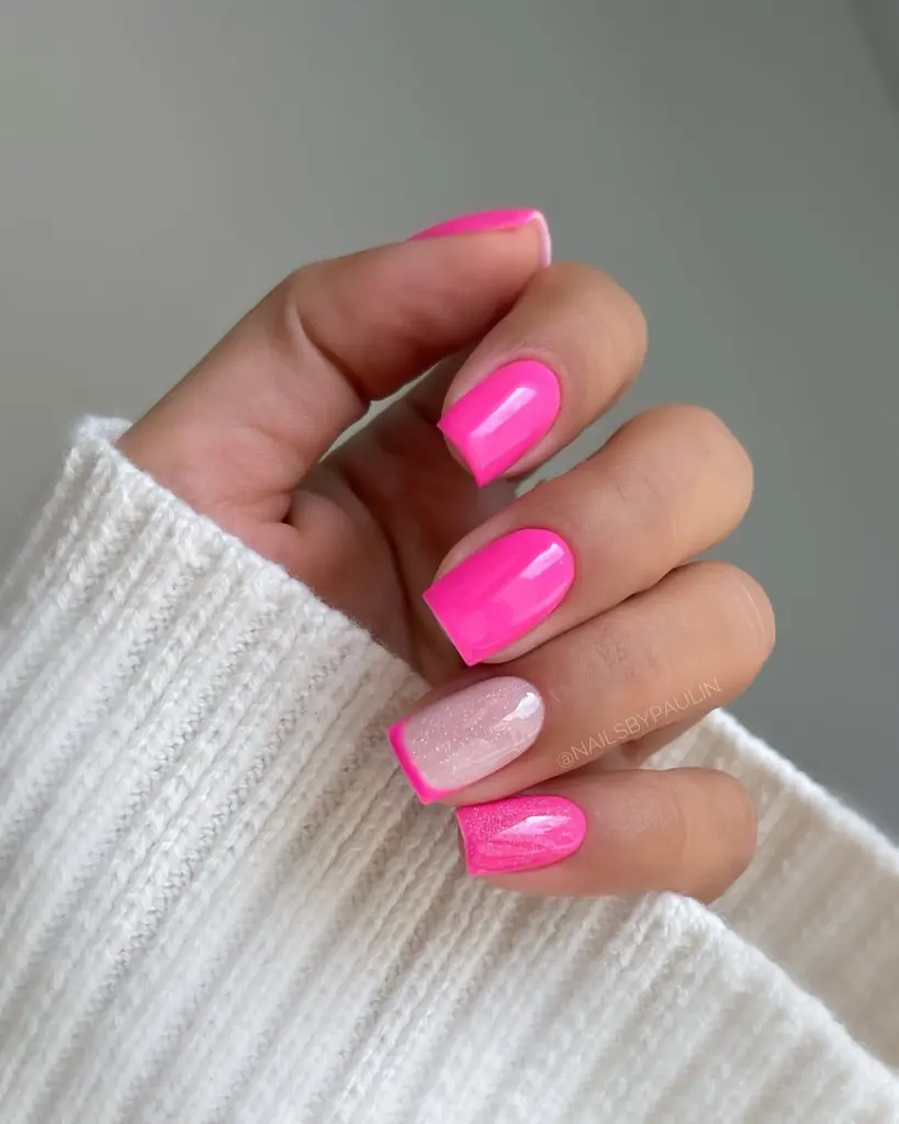 Classy short summer nails with vibrant hot pink polish, transparent glitter accent nail and pink French tips