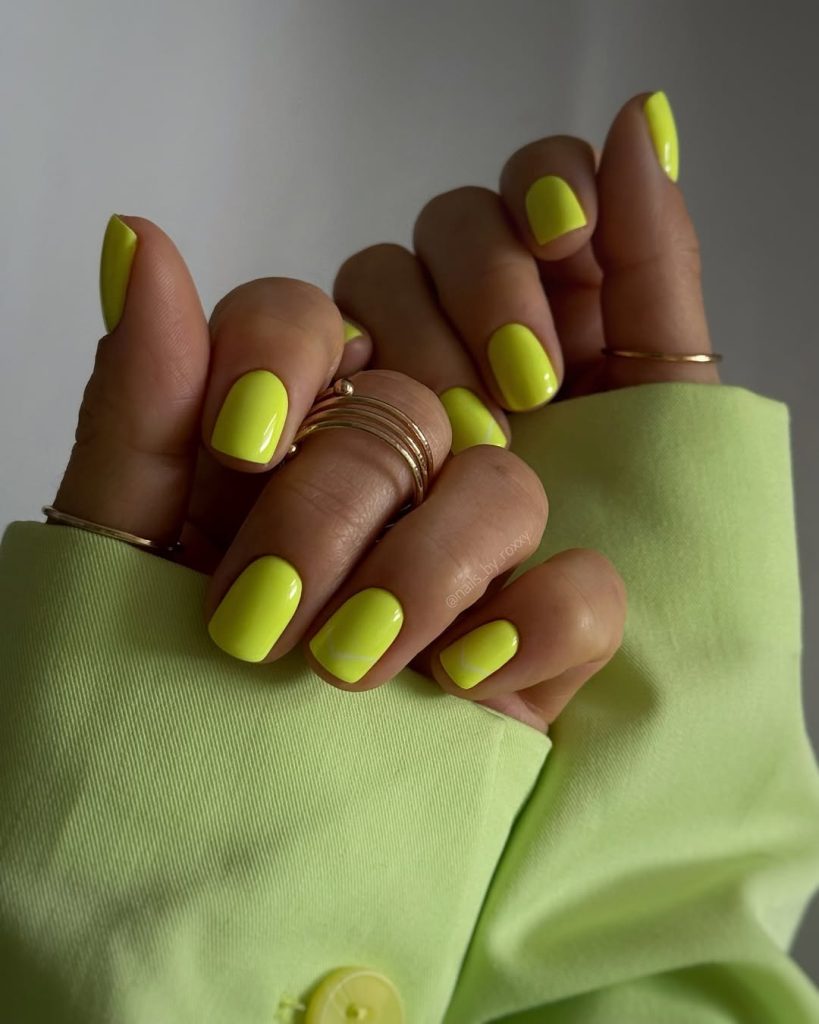 Short square neon chartreuse yellow nails with glossy finish for vibrant summer statement
