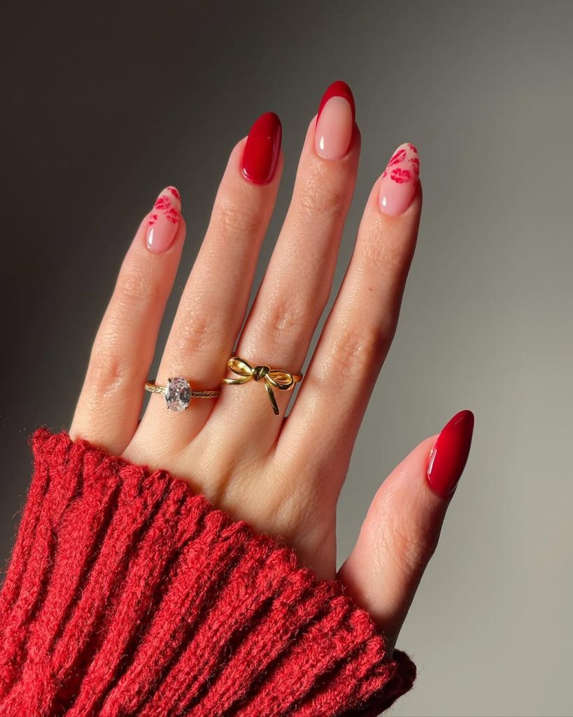 Almond shaped nails with alternating solid red polish, sheer pink with red French tips, and sheer pink with red lipstick kiss marks