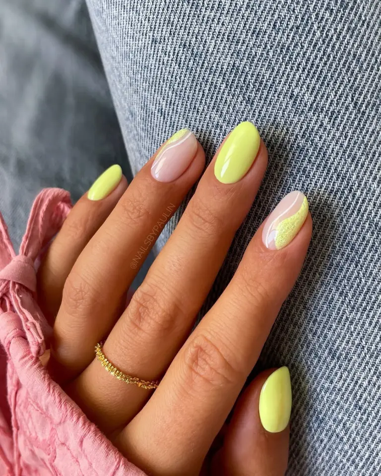 short oval July nails with bright yellow polish and milky base with yellow textured accent designs