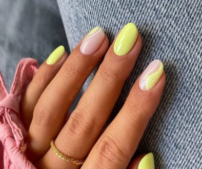 short oval July nails with bright yellow polish and milky base with yellow textured accent designs