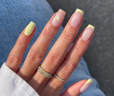 square summer nails with pastel yellow French tips, solid yellow accent nail and tiny lemon detail