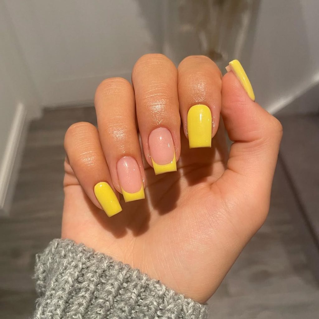 Square shaped summer nails with bright yellow French tips and alternating full yellow nails
