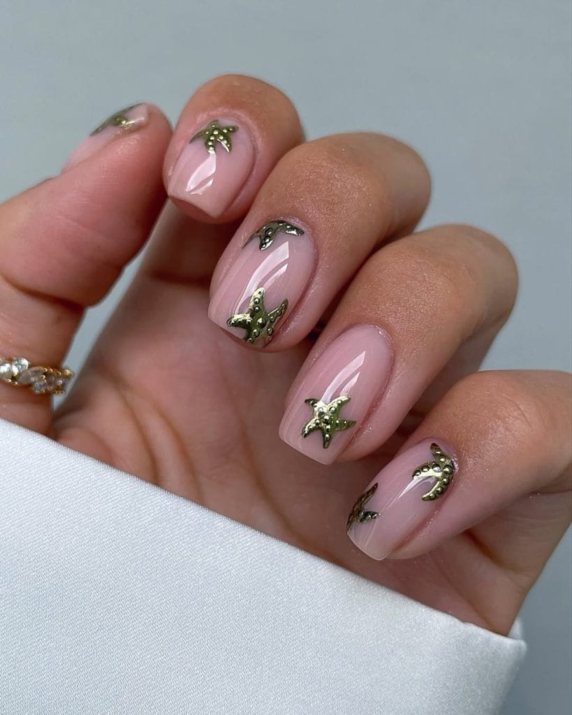  short square vacation nails with nude base and gold metallic starfish nail art
