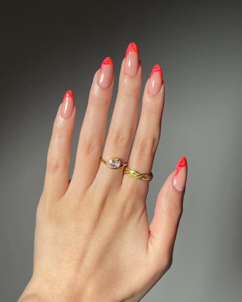 Almond shaped transparent pink nails with coral French tips and pink line details