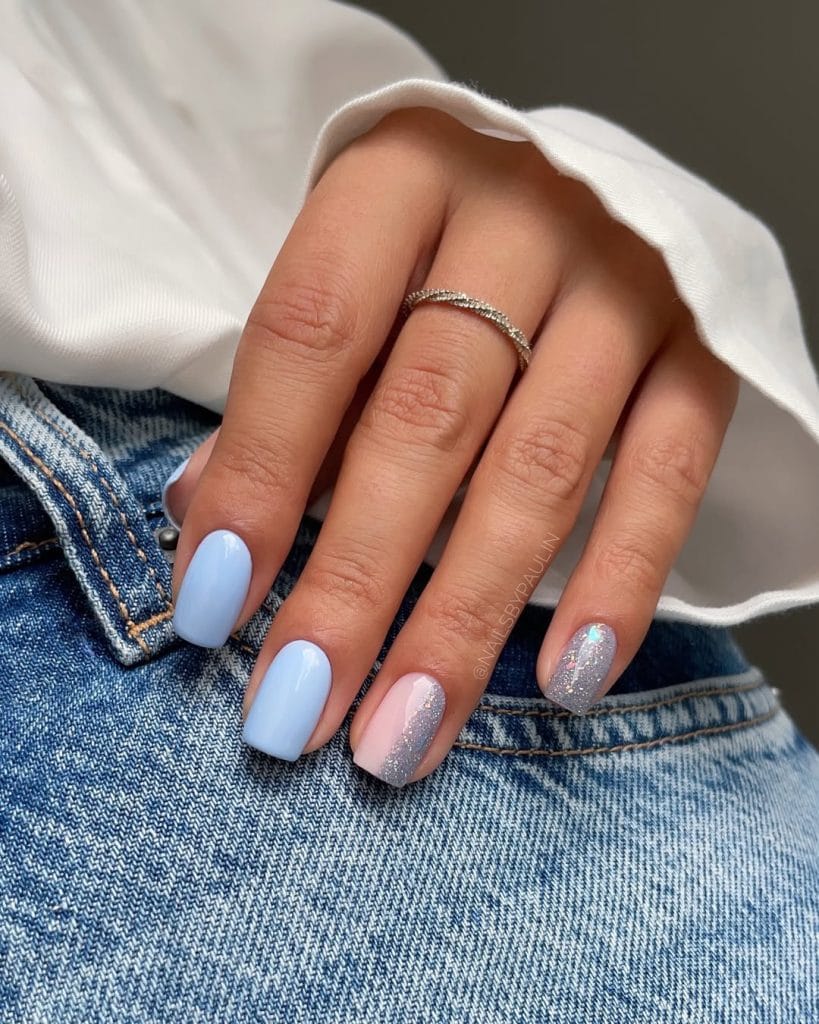 Elegant short summer nails with light blue polish and pink-to-silver glitter gradient accent nails