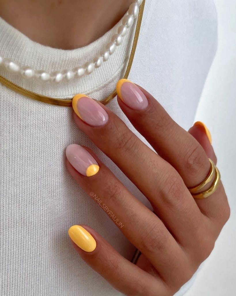 Classy short summer nails with milky base and bright yellow French tips and accent nail