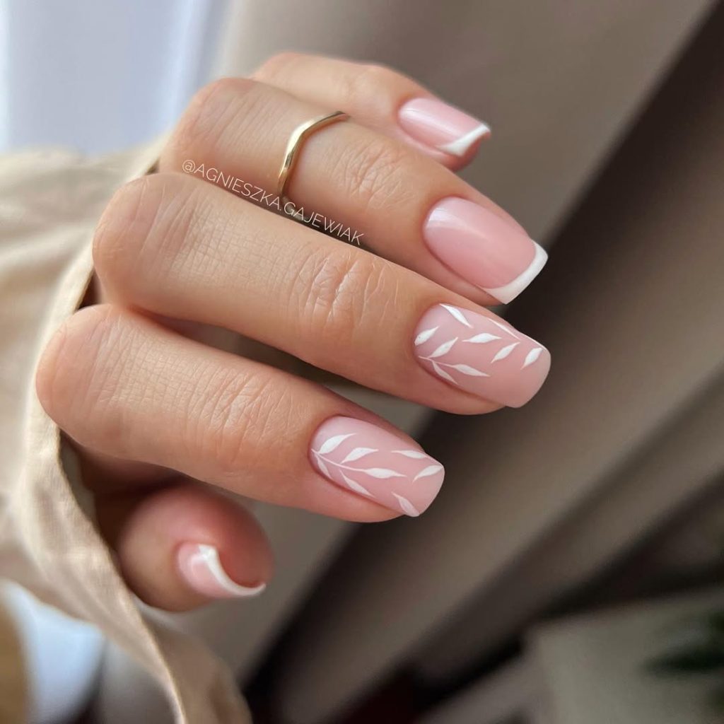 old money summer square nails with French tips and white leaf nail art on pink base
