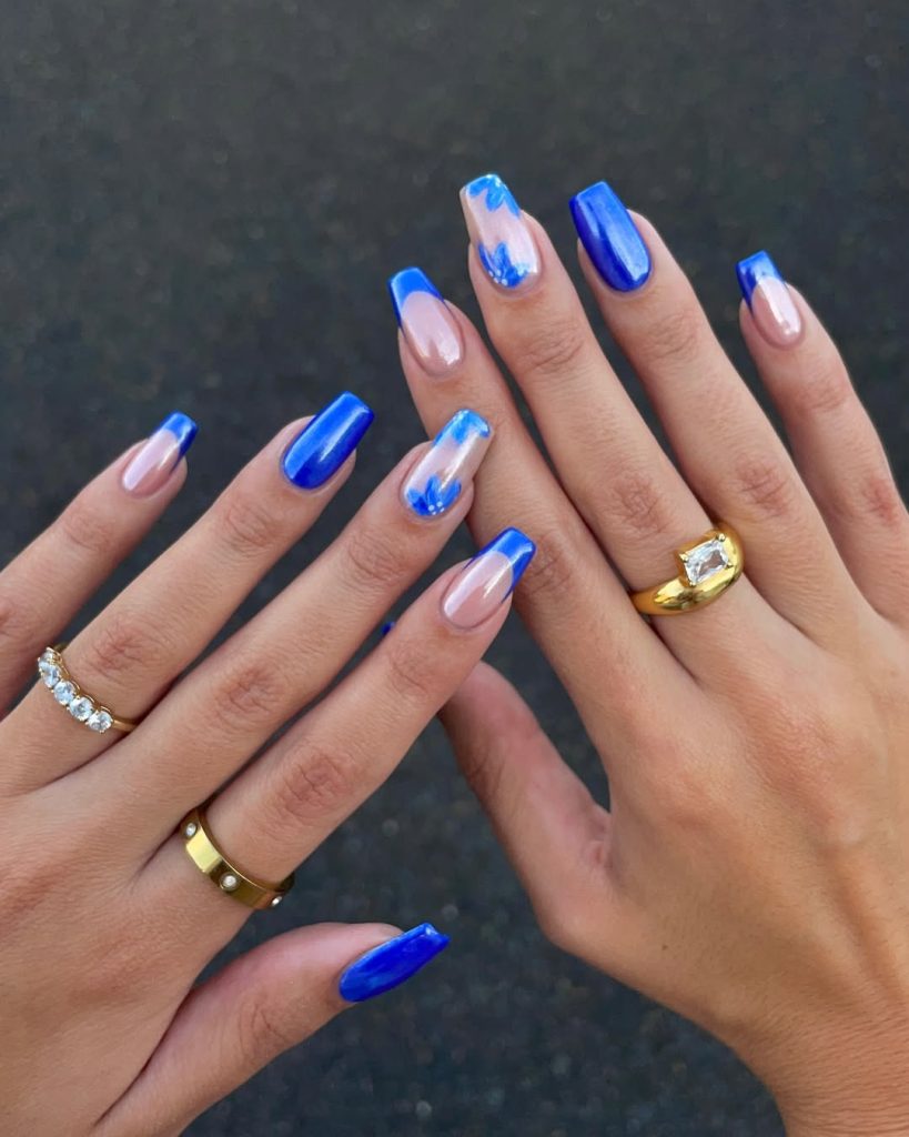 Square  nails with electric blue solid, French tips, and flower accents with glazed finish
