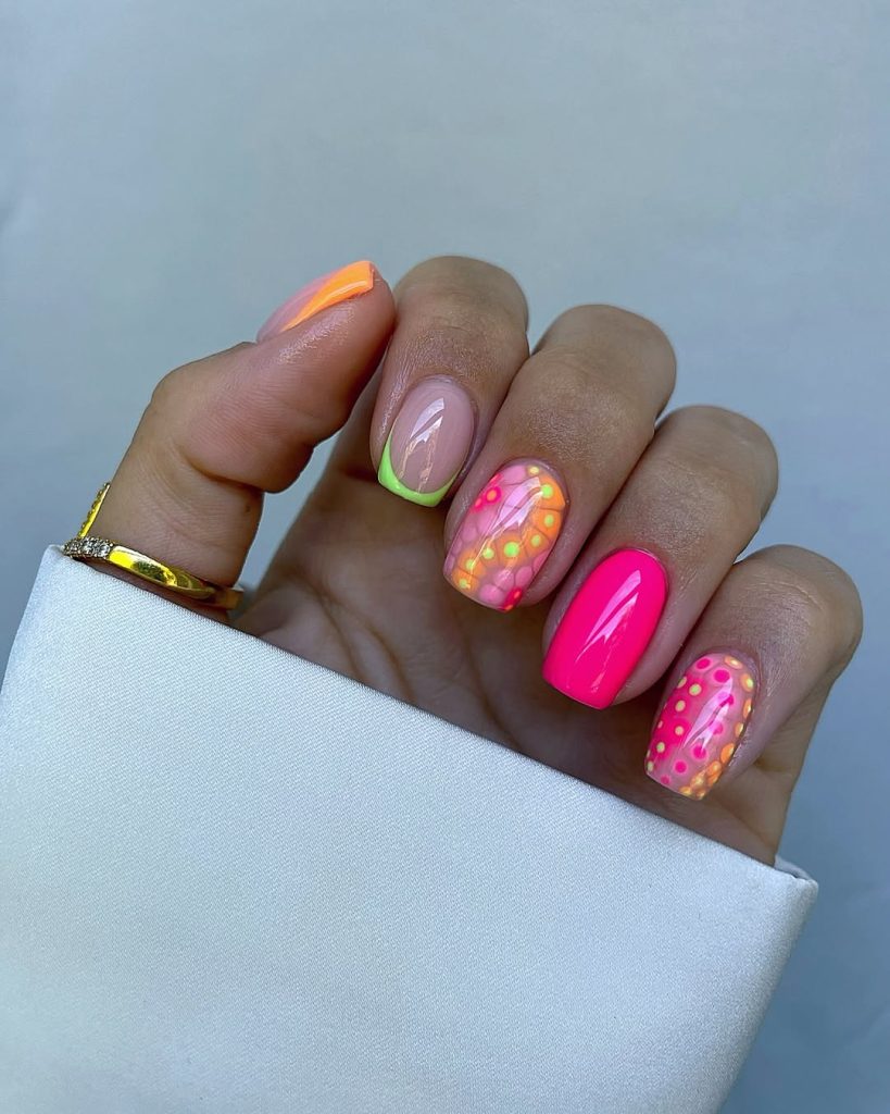 Short square neon mix nails with pink solid, neon French tip, and colorful dotted accent designs
