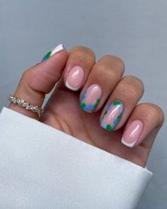 Classy short summer nails with pink base and white French tips, elegant watercolor blue and green floral accents on transparent background