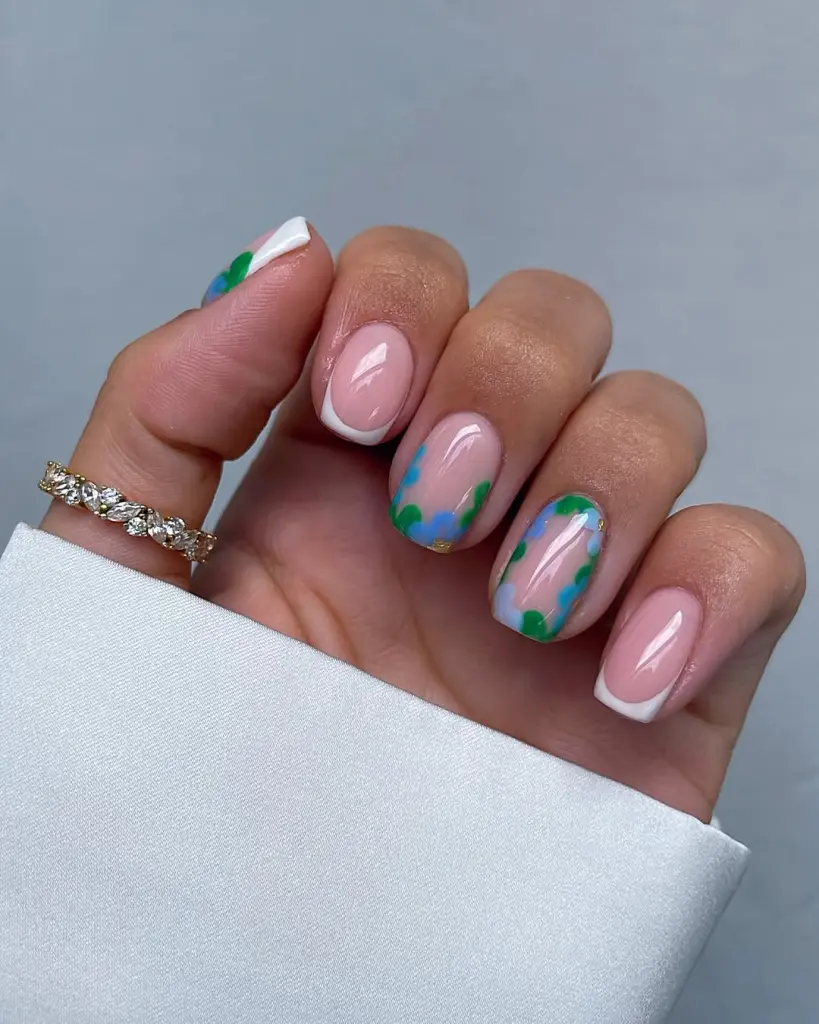 Classy short summer nails with pink base and white French tips, elegant watercolor blue and green floral accents on transparent background
