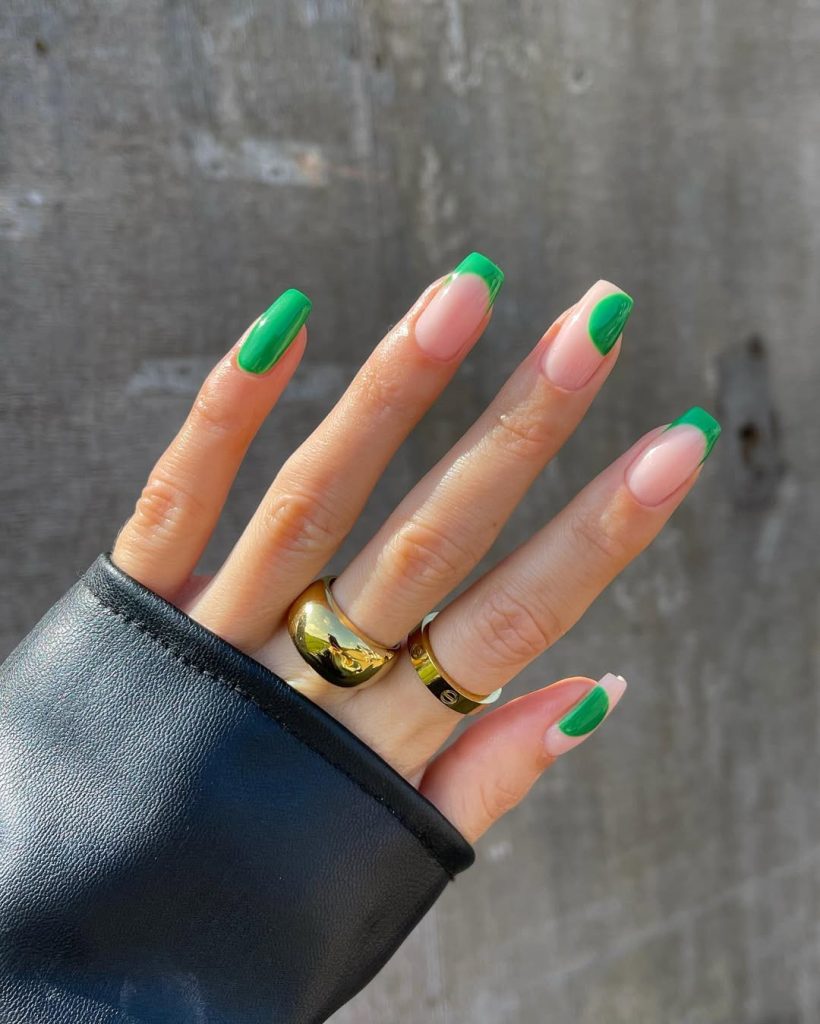 Square summer nails alternating between bright green full coverage and green French tips on pink base