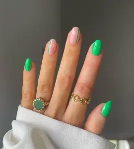 Short oval summer nails with bright green and pink mix featuring green accent stripes and solid green nails