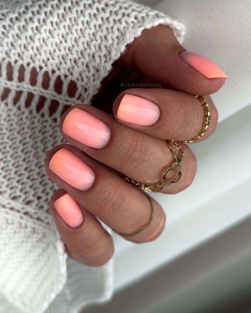 Short round vacation nails with matte coral pink polish
