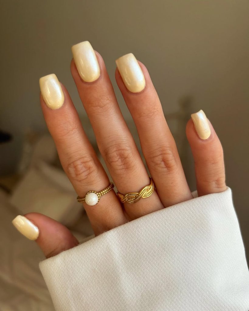 classy square nails with butter yellow chrome finish creating a glossy reflective summer manicure style