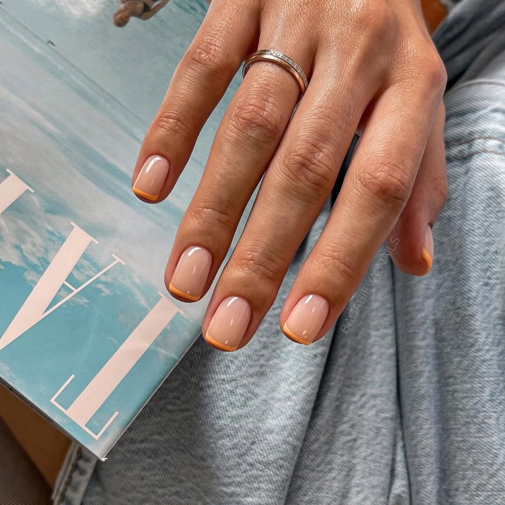 Short summer old money nude nails with delicate orange French tips