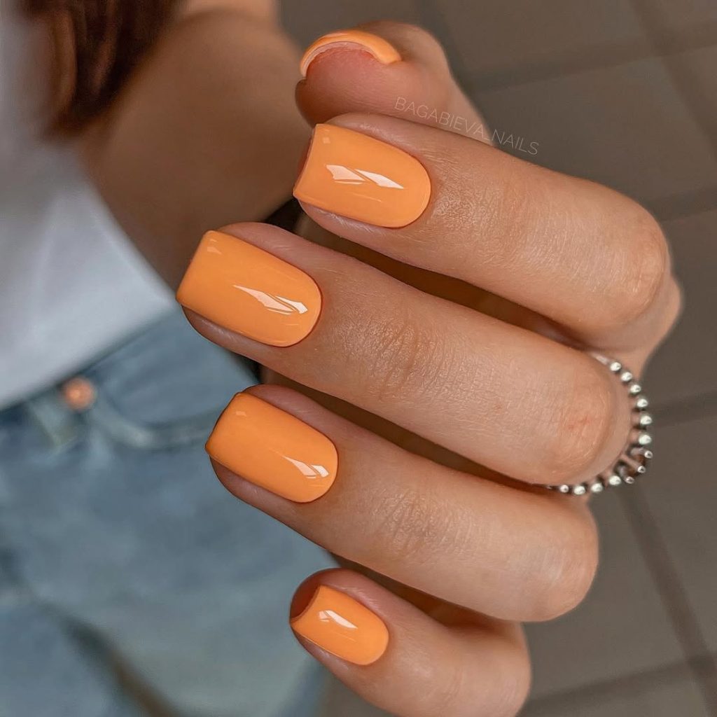 Short old money summer nails with glossy apricot orange polish