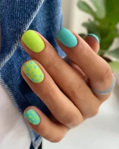 Short neon matte nails with lime green and turquoise polka dot pattern for vibrant summer style