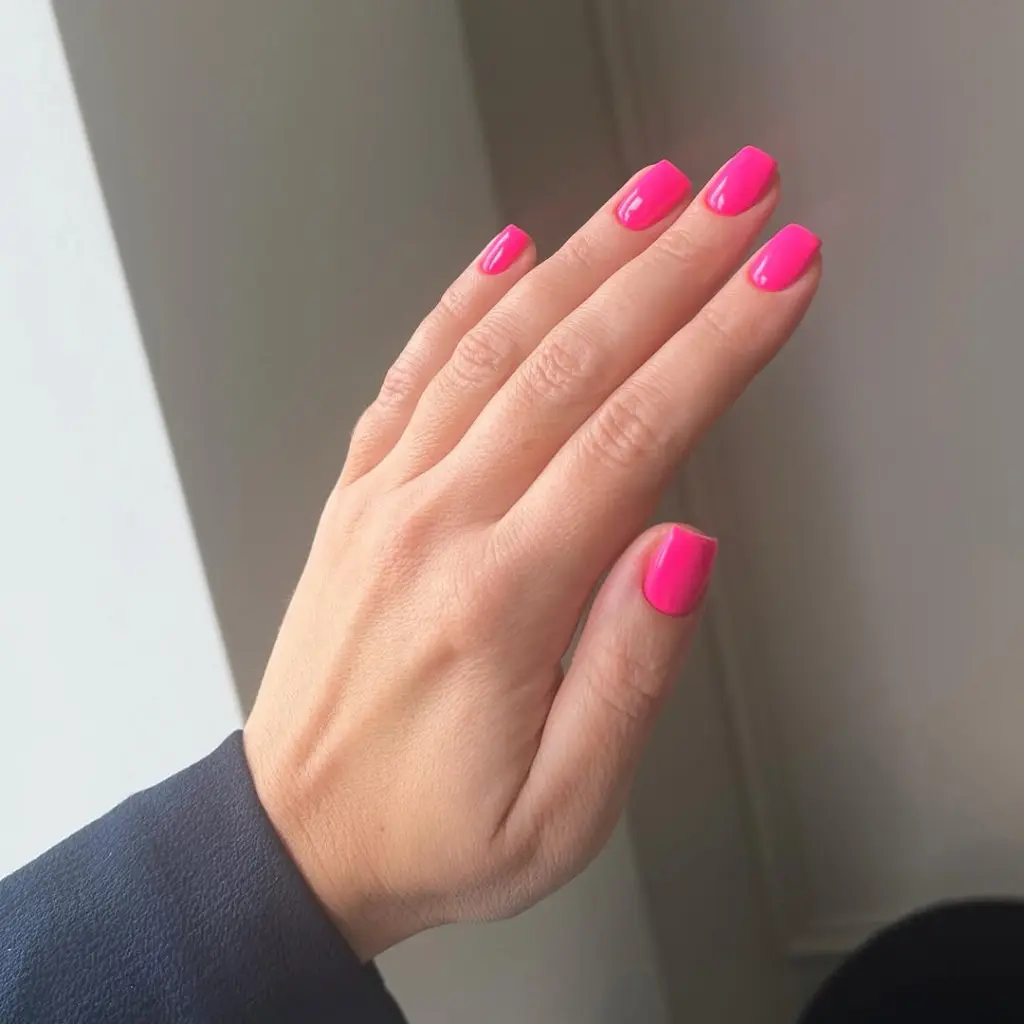 Short classy square nails in vibrant hot pink 