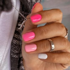 Classy short summer nails with pink ombré effect from hot pink to soft blush with white accent nail
