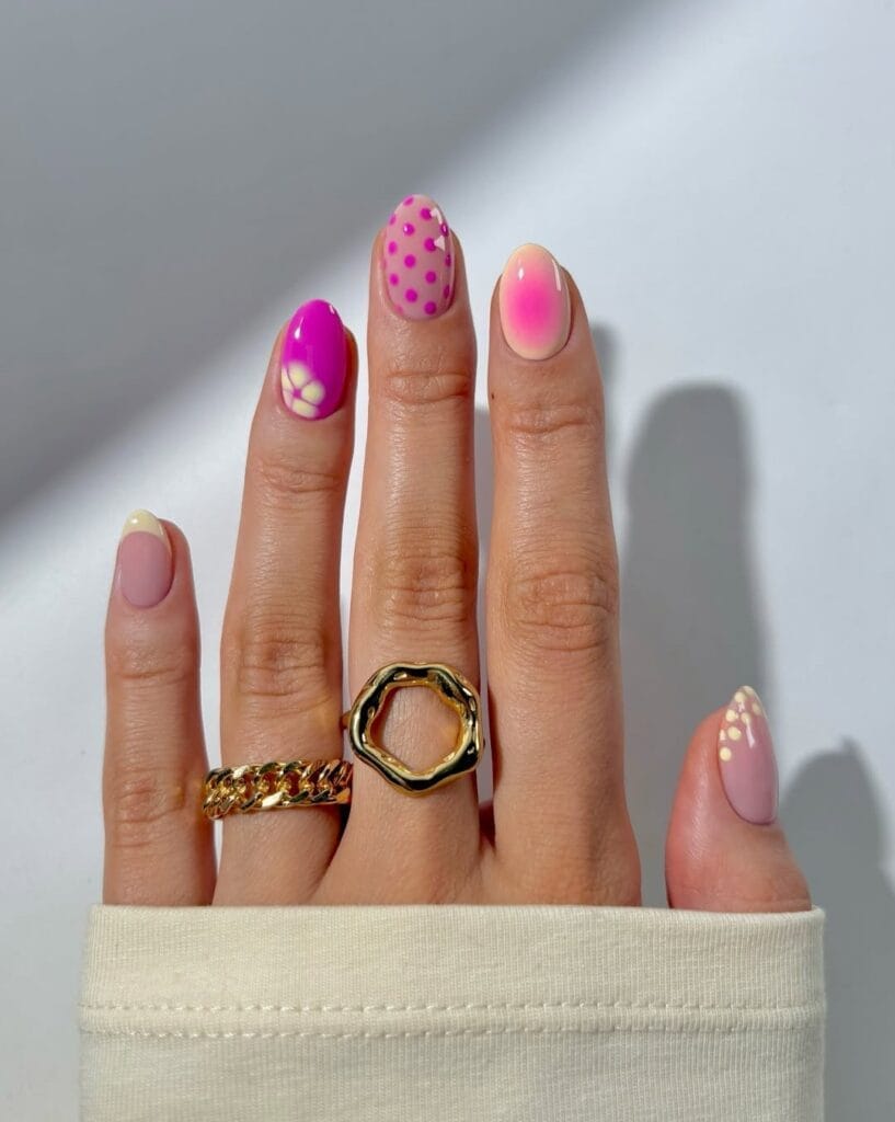 short summer nails, mixed pink set with polka dots, floral art, aura ombré, and French tip accents
