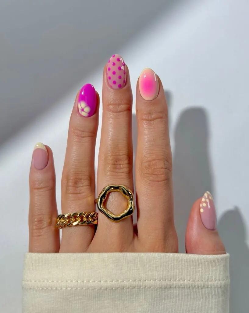 short summer nails, mixed pink set with polka dots, floral art, aura ombré, and French tip accents
