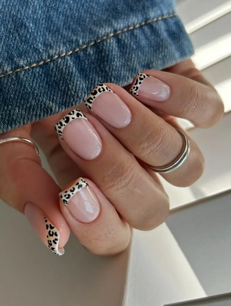 short summer nails, nude base with leopard print French tips in black and beige, round shape