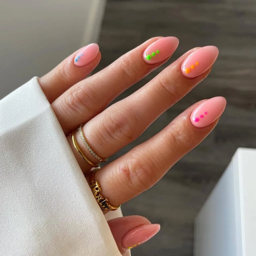 Almond simple summer nails with sheer pink base and tiny colorful neon dot trios near tips