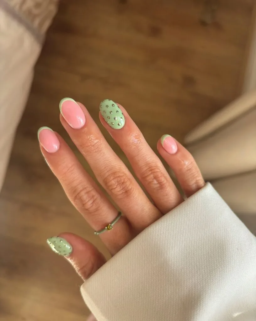 short summer nails, sage green French tips with gold dot accent nails, round shape
