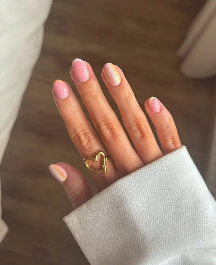 short summer nails, pearlescent pastel French tips and ombré accent nails on sheer round nails
