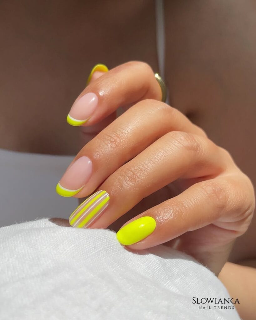  short summer nails, neon yellow French tips with white stripe accent nail on round shape, text "Slowianka Nail Trends"
