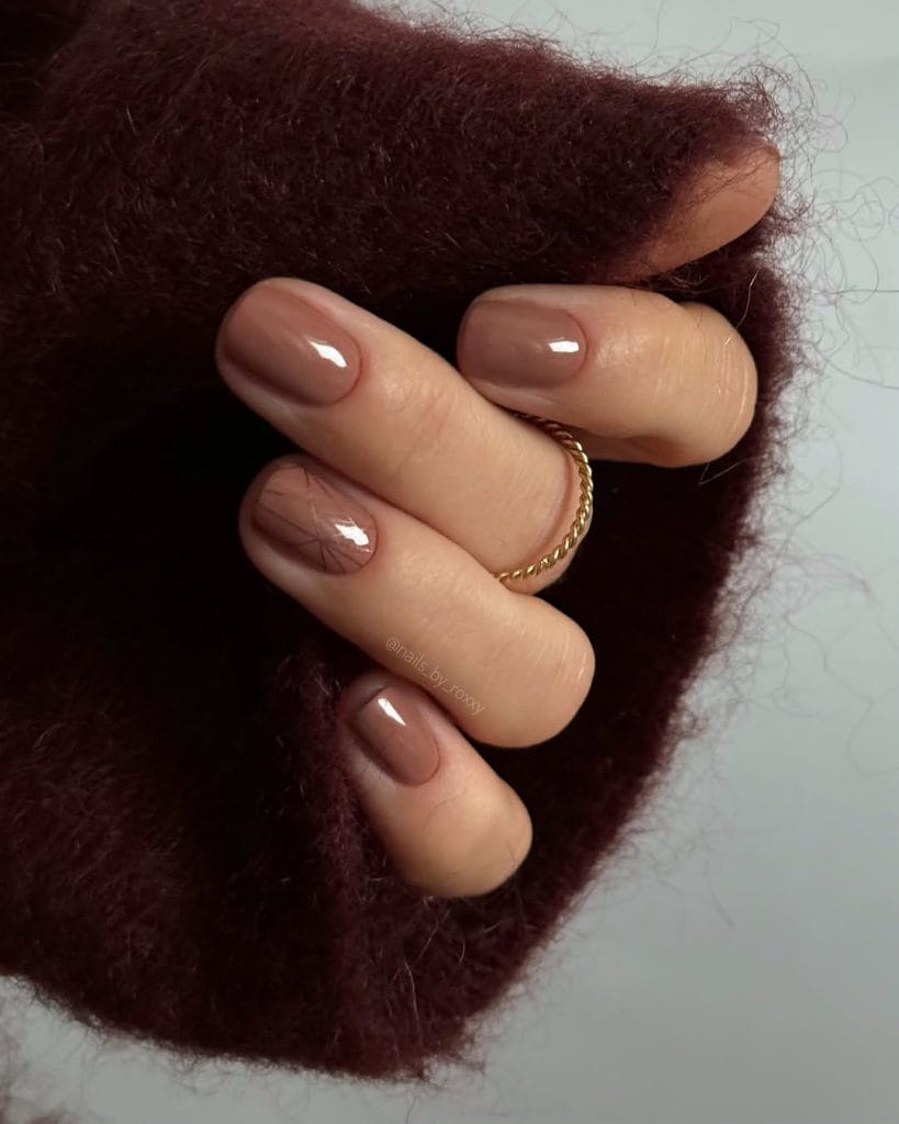 Short fall nails with warm taupe glossy polish and gold accent nail
