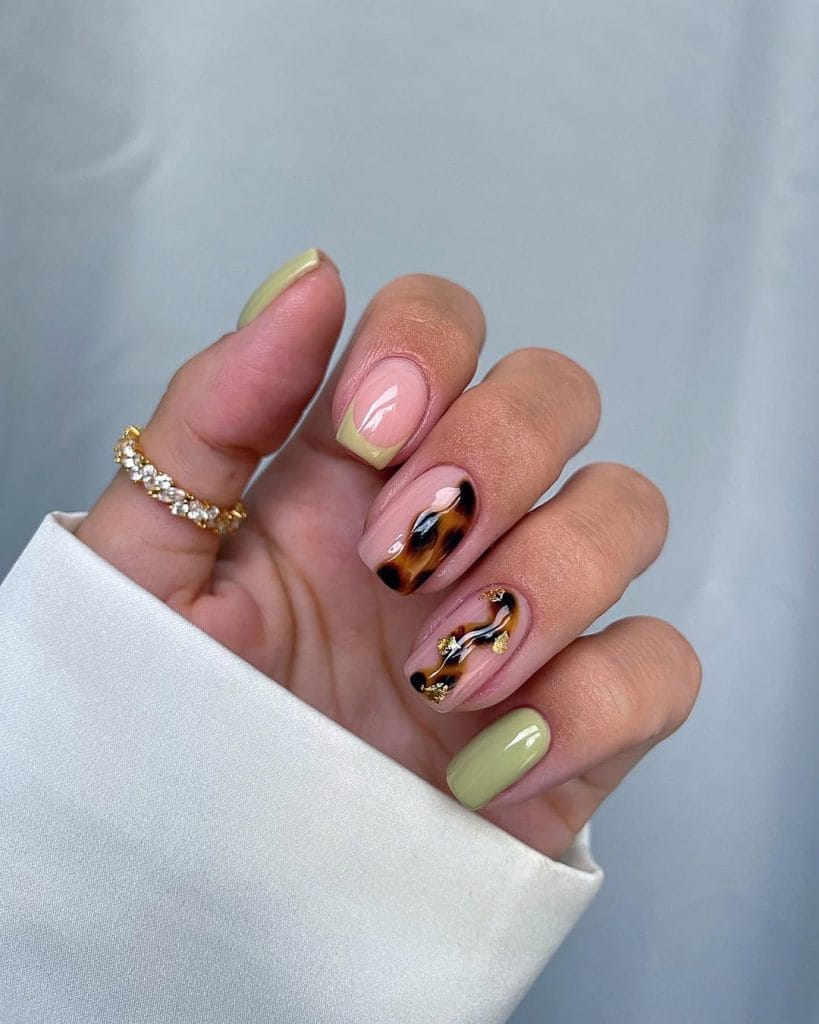 Short fall nails with pink base, abstract tortoiseshell design, sage green accents, and gold details
